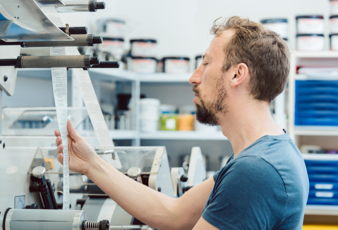 A technician prints labels using the new printing press.