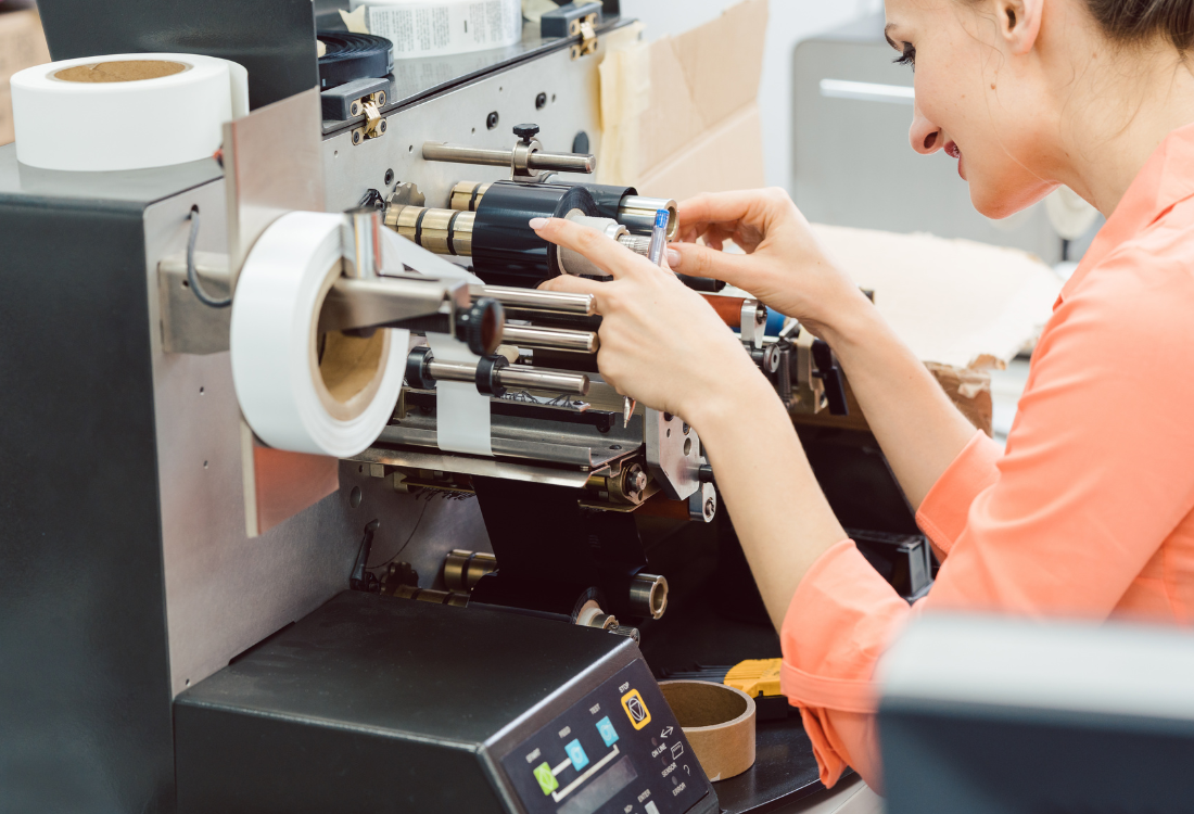 Woman operating a label printing machine.