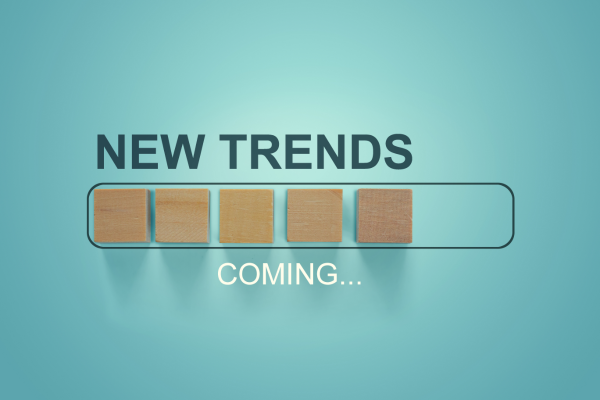 Wooden blocks with the word new trends in a loading bar progress showing how the label printing industry has new trends