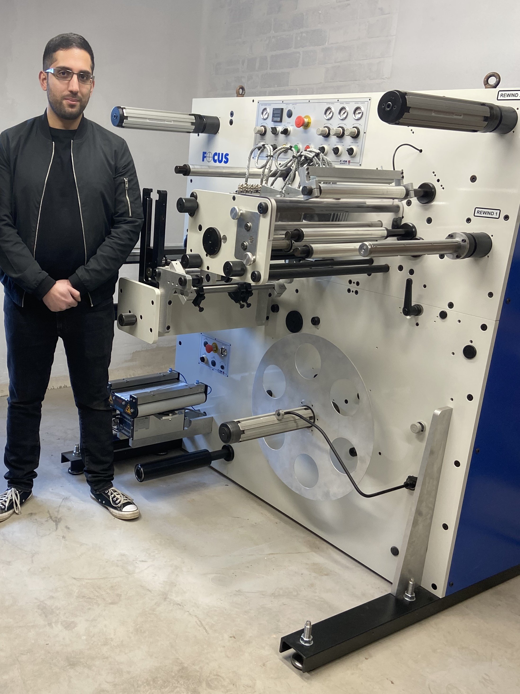 A man stood next to the latest FS 330 Series Slitter-Rewinder / Die-Cutter from Focus Label Machinery. 