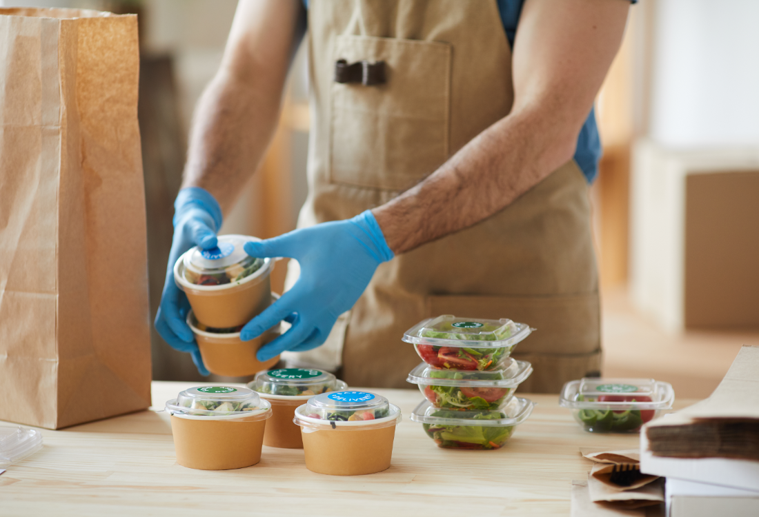 Food packaging with peel and reveal labels on takeaway containers, showing how multi-layer labels provide extra space for product information and promotions.