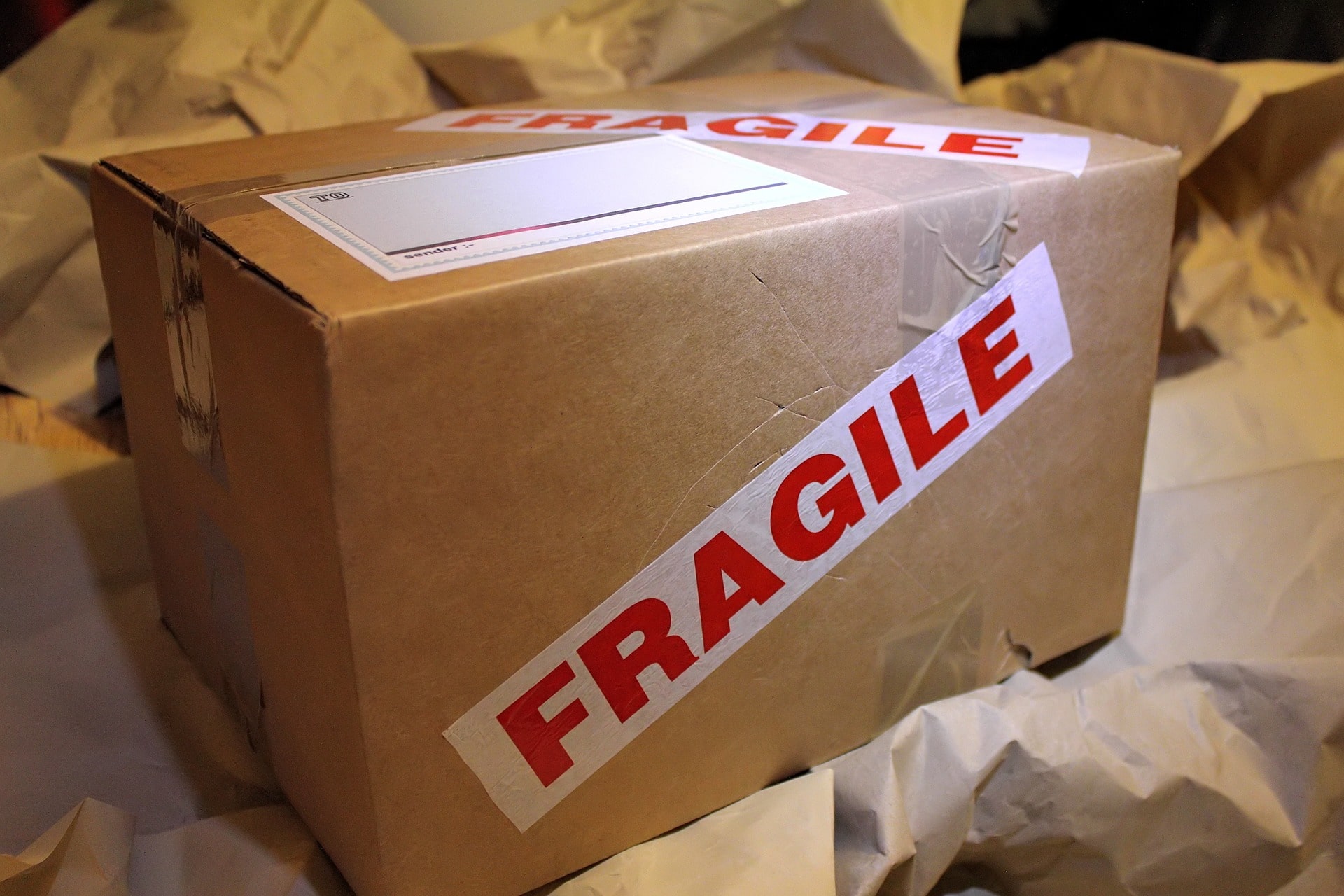 Boxes with 'fragile' labels on, showing the importance of security labels and tape in keeping parcels safe. 