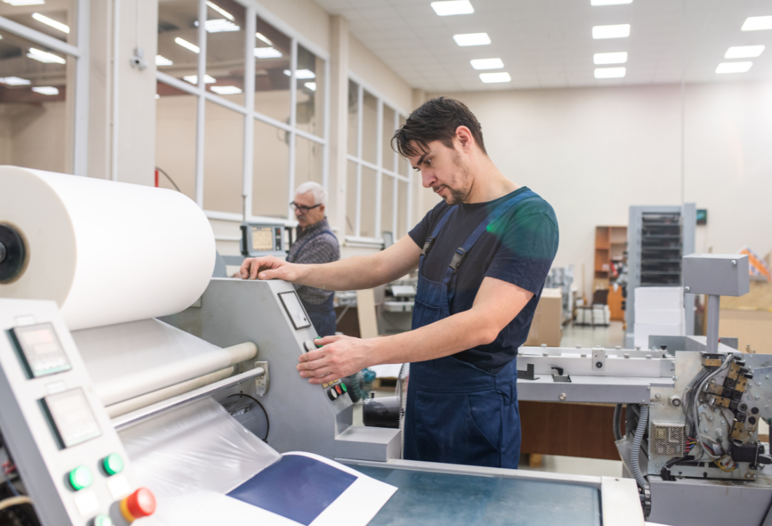 A man using a textile printing machine predicting the trends of 2025 until 2030.