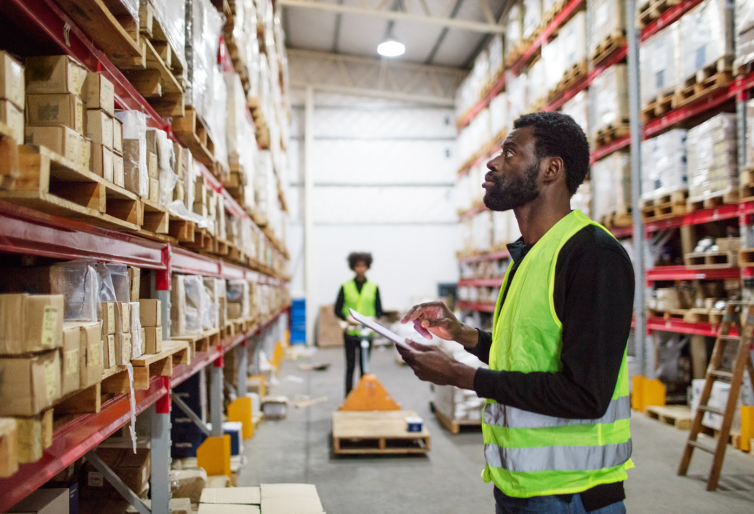 A man in a warehouse looking at packaging which have got smart labels on.